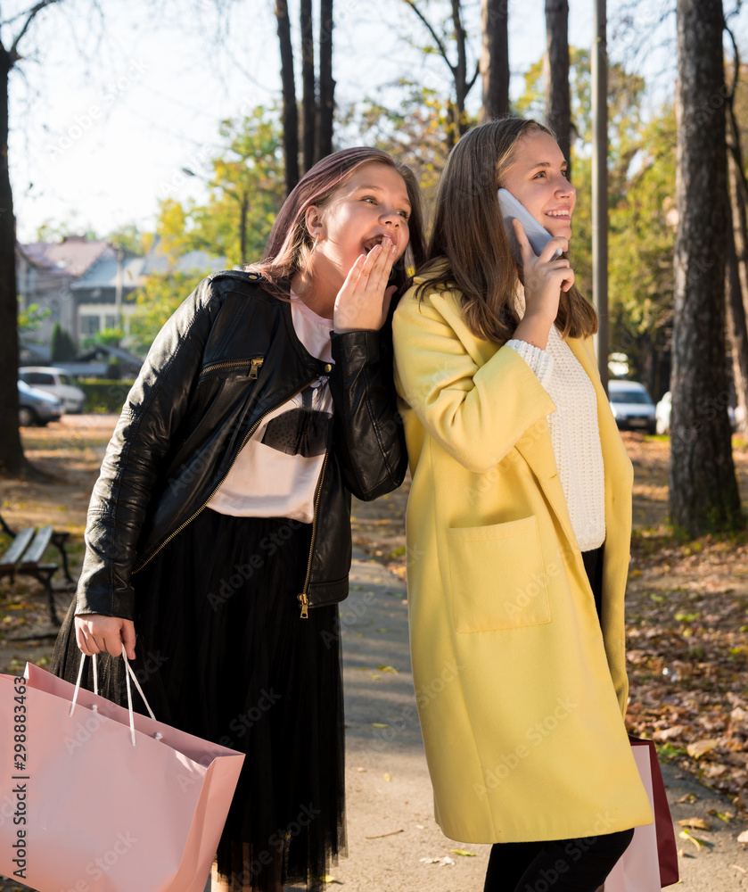 Beautiful teenage girls having fun in autumn street in suuny day Beautiful teenage girls having fun in autumn street in suuny day