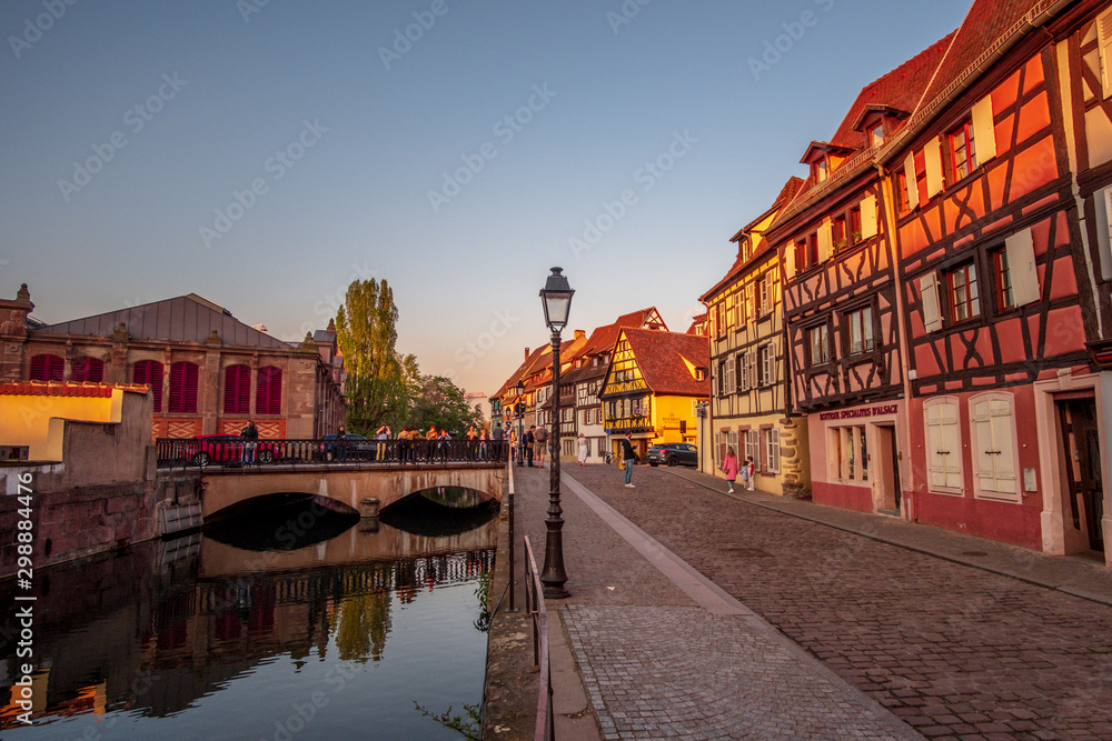 Beautiful sunset view in Petite Venice with water canal and traditional half timbered houses, Colmar, Alsace, France