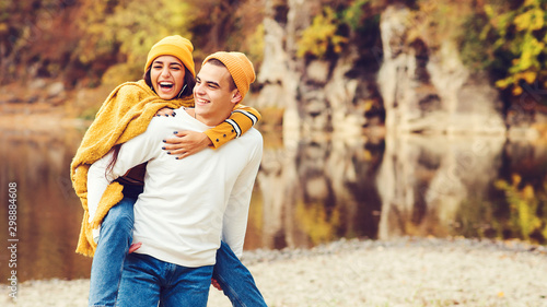 Happy fashionable couple having fun together outdoors. Love, relationship and fashion concept. Beauty and fashion. Autumn honeymoon on nature