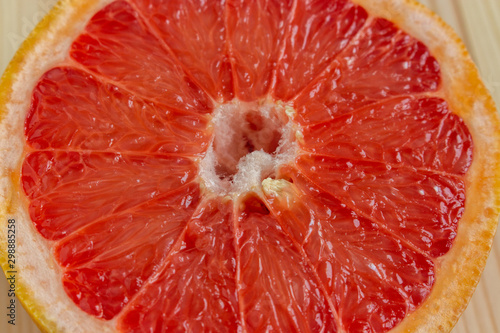 Red flesh of grapefruit close-up. Half of grapefruit, fresh citrus. Texture. Sour ripe juicy fruit