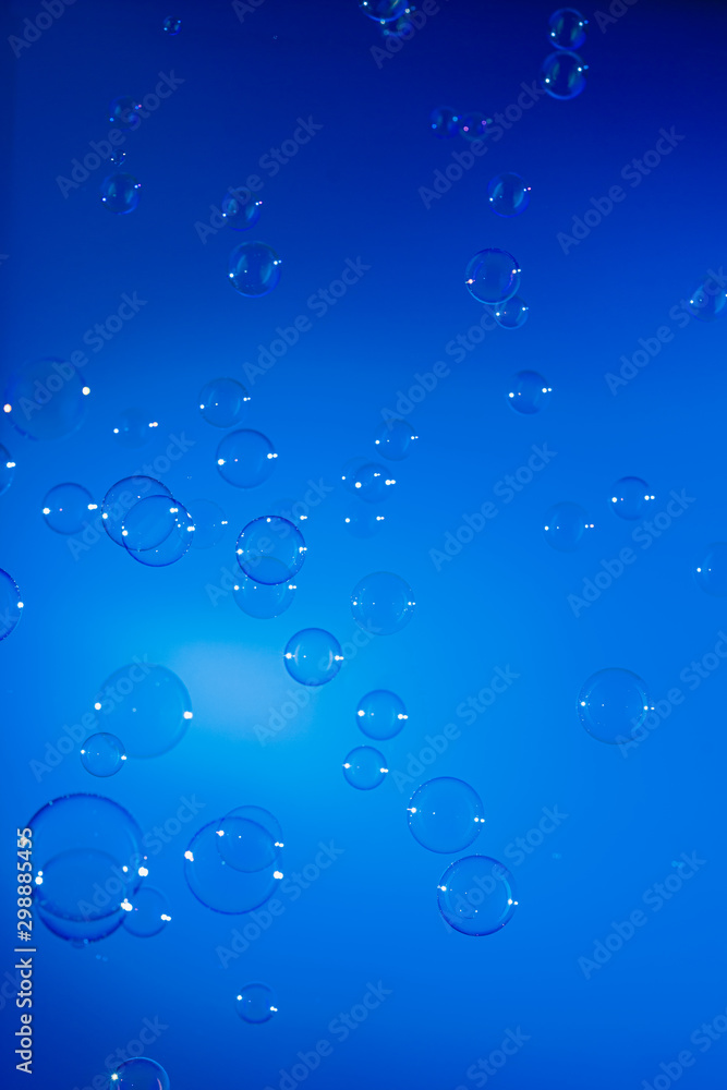 soap bubbles in air with  float on blue background