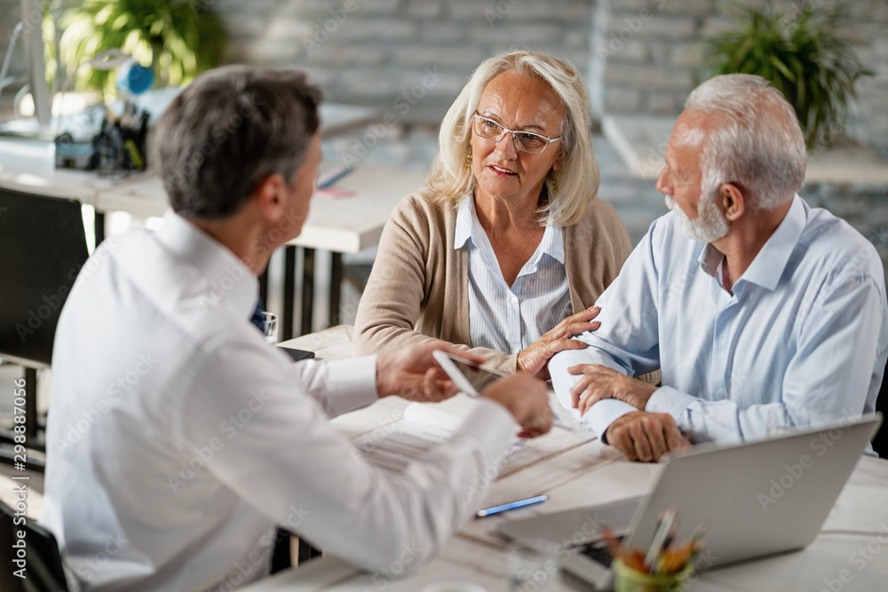 Senior woman and her husband having a meeting with financial advisor in the office. Senior woman and her husband having a meeting with financial advisor in the office.