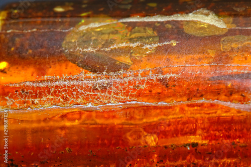 Trendy multicolored luxury background. Amber texture macro shot. Fossilized petrified resin of a tree. Sun stone. Color. Natural mineral as a material for jewelers. Crystal