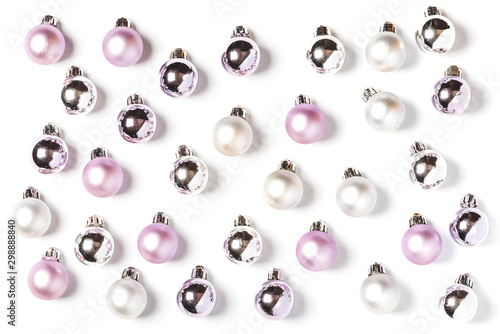 Pink, white and silver christmas balls pattern, minimal style. Christmas decorations on a white background, top view, flat lay.
