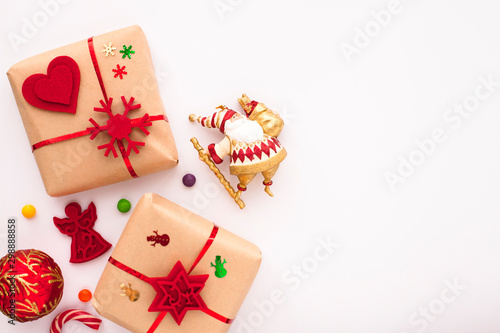 Christmas composition. Beautiful toys, gifts and candy on the white background. New year background. Top view. Close up. Space for a text.