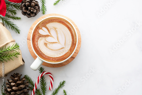 Leinwand Poster White marble table with cup of latte coffee and Christmas decoration with gift box