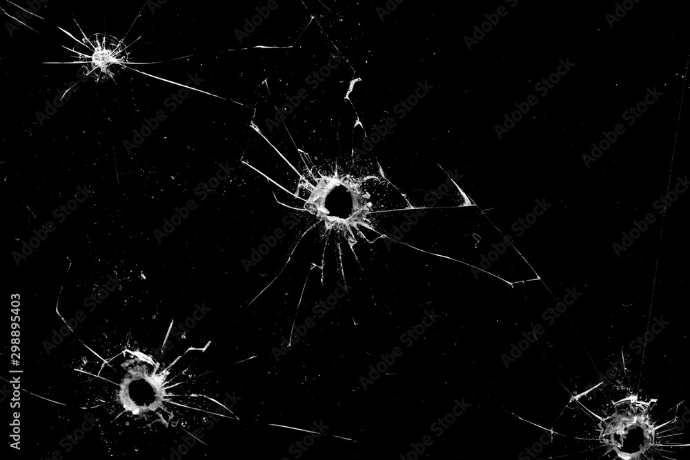 holes in the glass with cracks isolated on a black - obrazy, fototapety, plakaty 