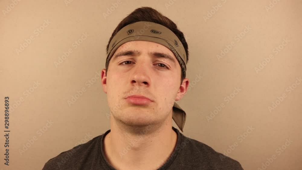 man facepalm on a plain beige background man facepalm on a plain beige background