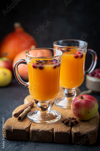 Spicy hot pumpkin punch or sangria in a glass with apple, cinnamon, anise. Halloween and Thanksgiving. Traditional autumn, winter drinks and cocktails