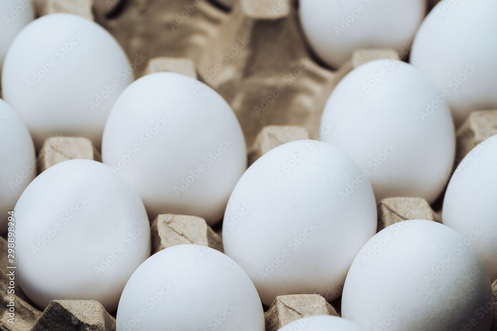 Carton tray with Chicken white eggs. Empty cells in the middle. Closeup. Farm products and natural eggs. Healthy food. Carton tray with Chicken white eggs. Empty cells in the middle. Closeup. Farm products and natural eggs. Healthy food.