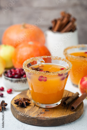 Spicy hot pumpkin punch or sangria in a glass with apple, cinnamon, anise. Halloween and Thanksgiving. Traditional autumn, winter drinks and cocktails