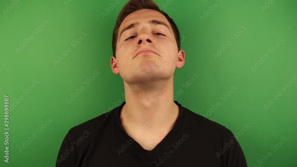 man uses perfume on himself on green background man uses perfume on himself on green background