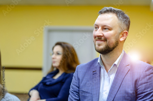 Closeup portrait of a smiling young man. Confident businessman in white collar shirt. Portrait of a Male with Beard.