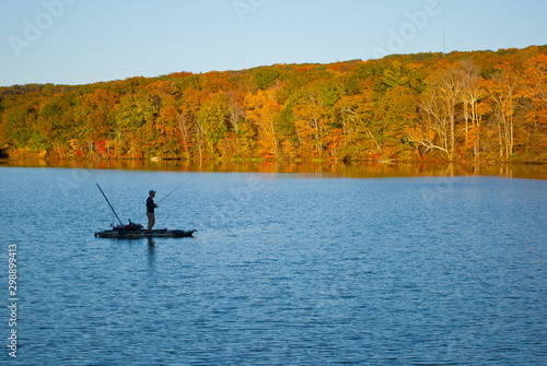 Fishrman in Risley Park Vernon Connecticut during autumn fall with beautfull foliage