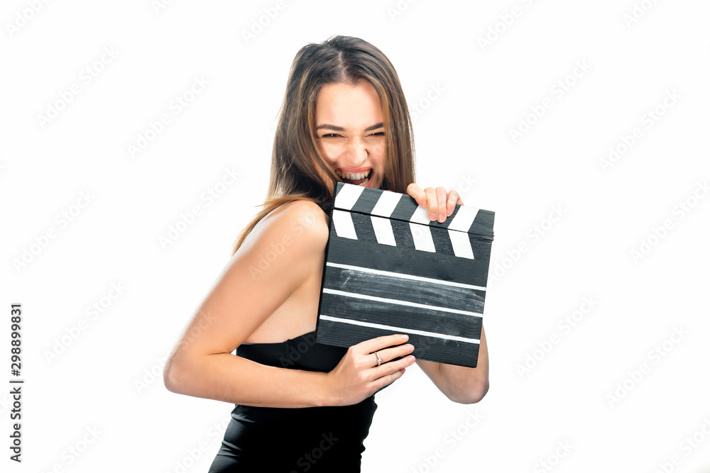 Girl with clapper board. People's emotions. Isolated background. Close up. Beauty is winking to the camera. Closeup. Girl with clapper board. People's emotions. Isolated background. Close up. Beauty is winking to the camera. Closeup.