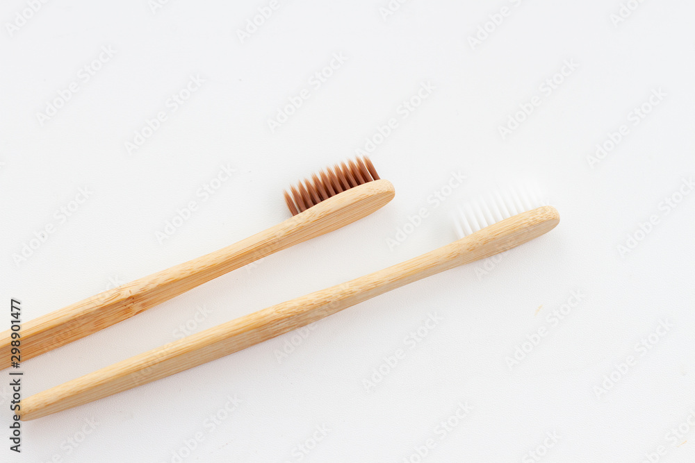 Natural bamboo toothbrush on whita background. Flat with a bamboo handle. Eco concept health and care Natural bamboo toothbrush on whita background. Flat with a bamboo handle. Eco concept health and care