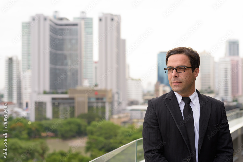 Handsome Persian businessman against view of the city Handsome Persian businessman against view of the city