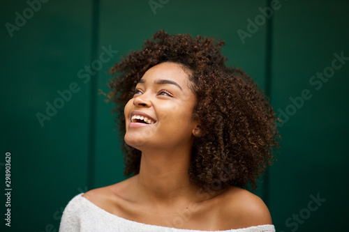 Vászonkép Close up young african american woman smiling and looking up