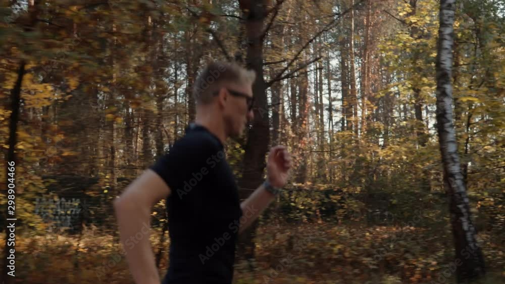 Runner Man Running And Preparing To Triathlon Marathon And Sprinting In Park On Fall.Running Man On Forest Road Half Marathon.Triathlete Ready For Marathon And Hard Training Before Running Competition Runner Man Running And Preparing To Triathlon Marathon And Sprinting In Park On Fall.Running Man On Forest Road Half Marathon.Triathlete Ready For Marathon And Hard Training Before Running Competition