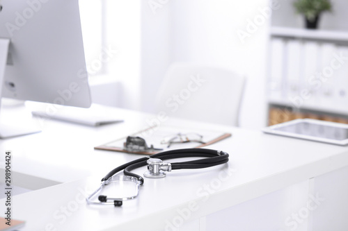 Stethoscope  prescription medical form lying on a table with pc computer. Medicine or pharmacy concept. Medical tools at doctor working table