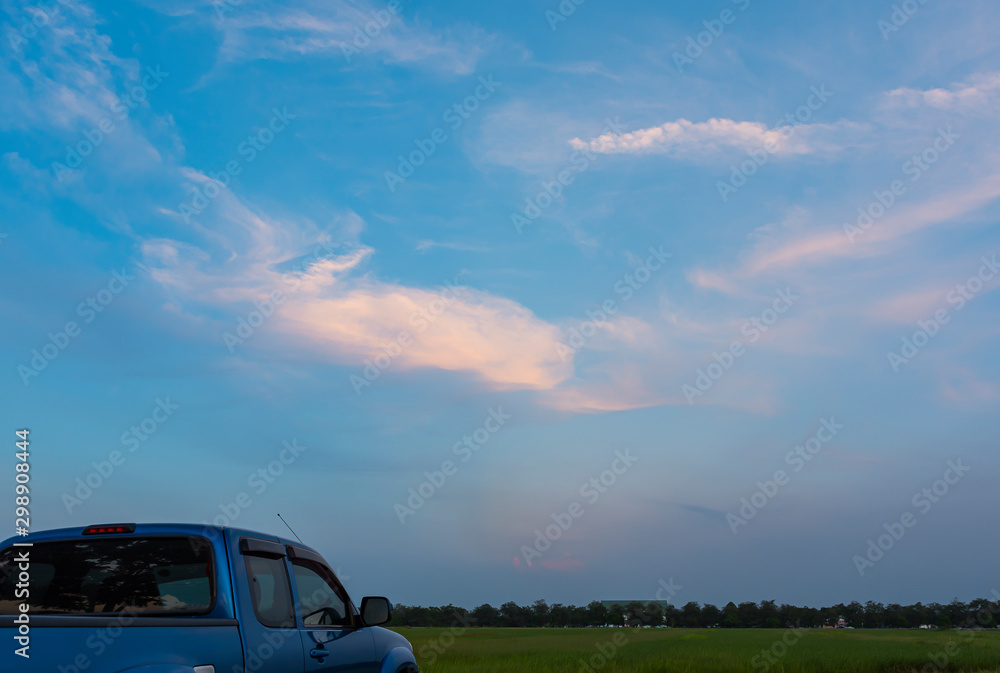Blue pickup truck at sunset sky