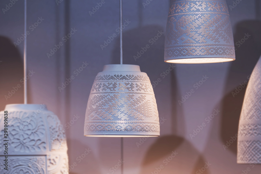 Fotografie White ceramic pendant lights, chandeliers with ethnic patterns with a light bulb inside