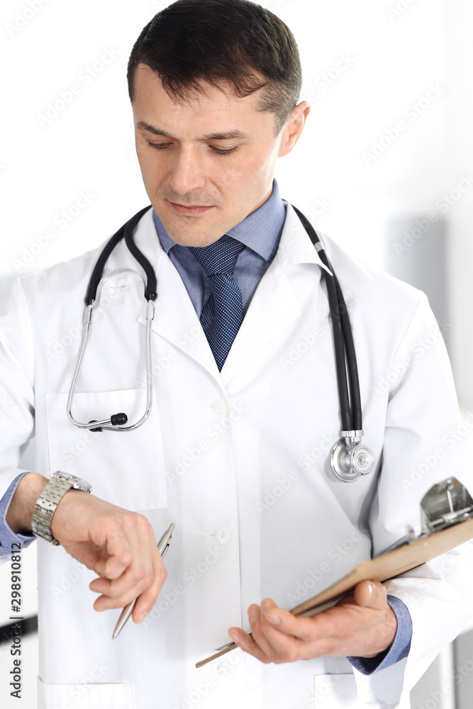 Doctor man using clipboard for filling up medication history records. Perfect medical service in clinic. Physician at work in hospital. Medicine and healthcare concepts Doctor man using clipboard for filling up medication history records. Perfect medical service in clinic. Physician at work in hospital. Medicine and healthcare concepts