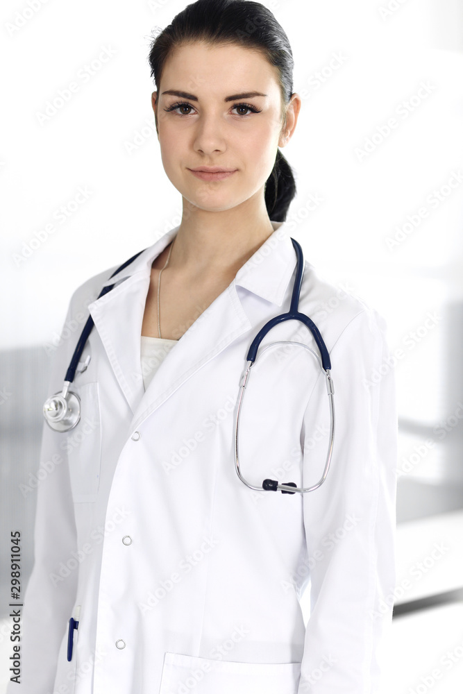 Doctor woman cheerful smiling at camera. Perfect medical service in clinic. Happy future in medicine and healthcare Doctor woman cheerful smiling at camera. Perfect medical service in clinic. Happy future in medicine and healthcare