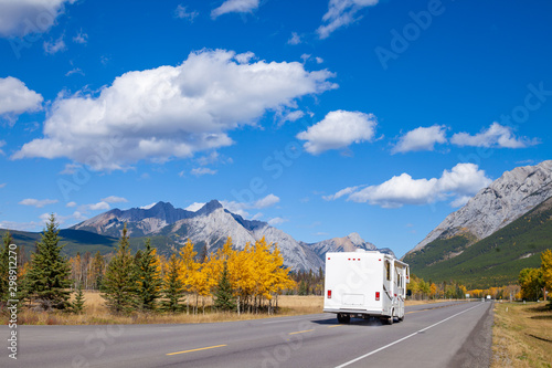 An RV aon the highway through the Canadian Rocky Mountains in Kananaskis, Alberta, Canada during the peak of autumn colors