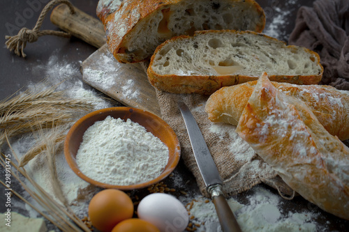 Bread in a composition with kitchen accessories on an old background