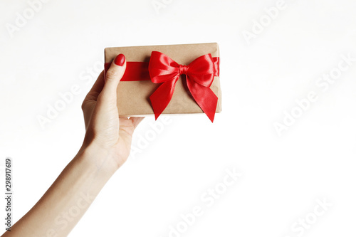 Fototapeta Naklejka Na Ścianę i Meble -  Gift box in a female hand on white