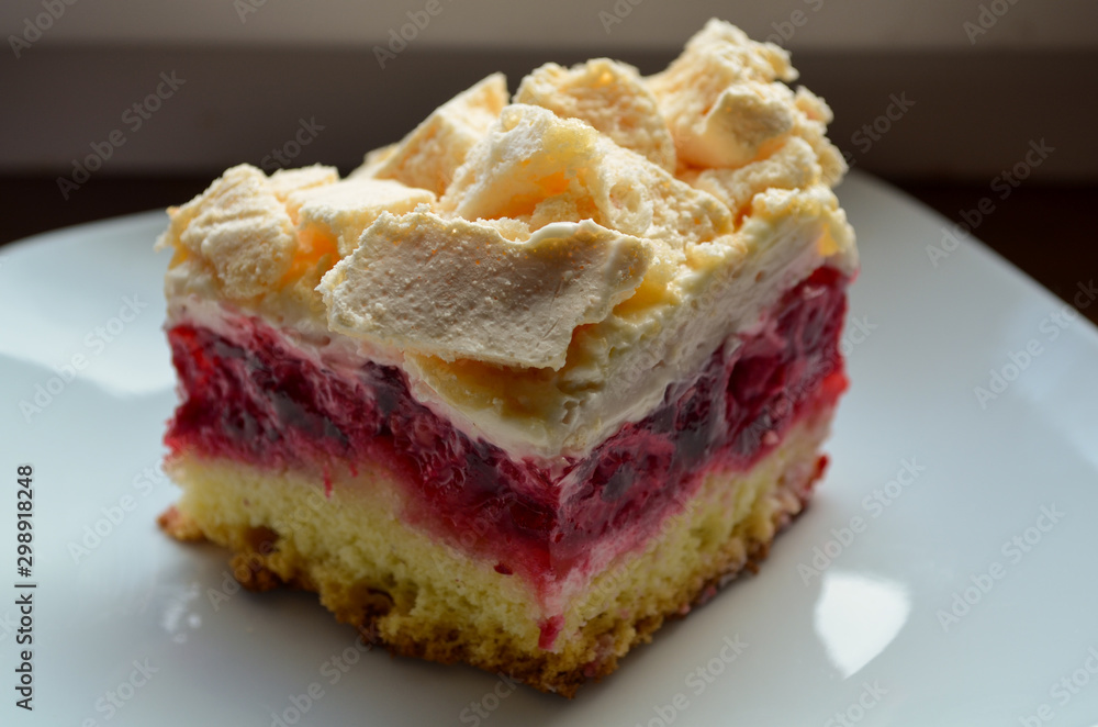 Closeup of cookies with raspberries, cream and meringue on a plate Closeup of cookies with raspberries, cream and meringue on a plate