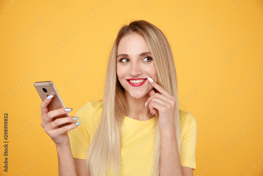Happy blond woman using phone in the studio Happy blond woman using phone in the studio