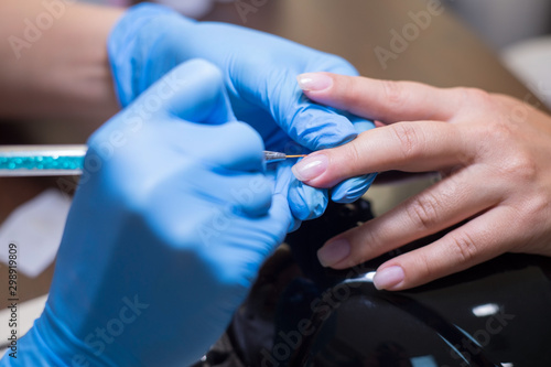 woman master manicure. Girl does manicure in a beauty salon