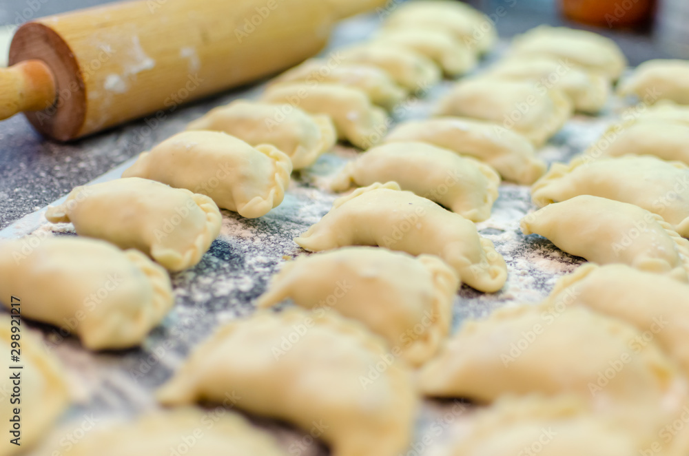 Preparing dumplings in the kitchen. Raw dumpling with potatoes Preparing dumplings in the kitchen. Raw dumpling with potatoes