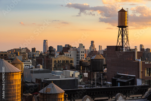 Summer Sunset light on Chelsea rooftops with water towers, Manhattan, New York City, NY, USA