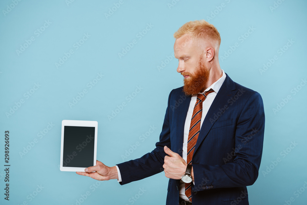 bearded businessman in suit showing digital tablet with blank screen, isolated on blue bearded businessman in suit showing digital tablet with blank screen, isolated on blue
