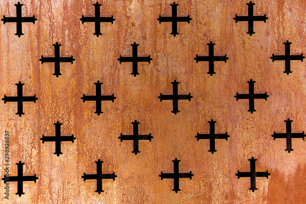 Rust metal perforation of a cross pattern