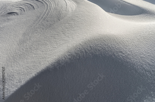 Snow covered field texture. Abstract winter background in white tones.