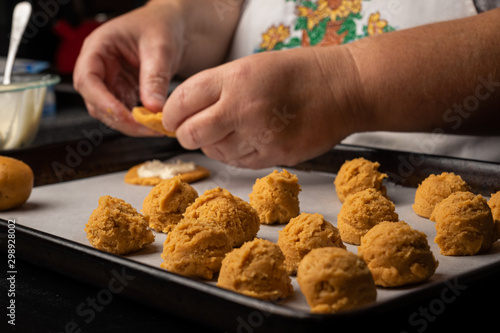 A cook prepares raw cookies for the oven