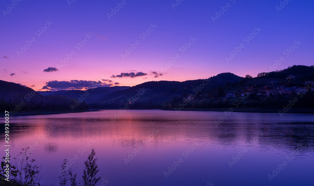 purple sky at sunset over mountain and lake landscape