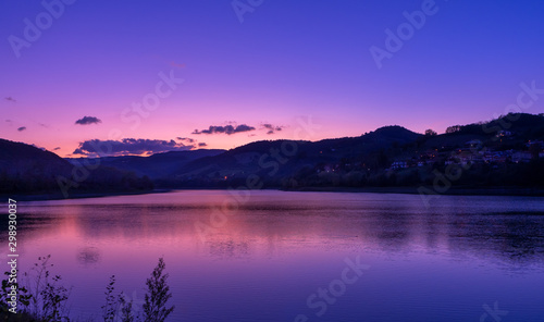 purple sky at sunset over mountain and lake landscape
