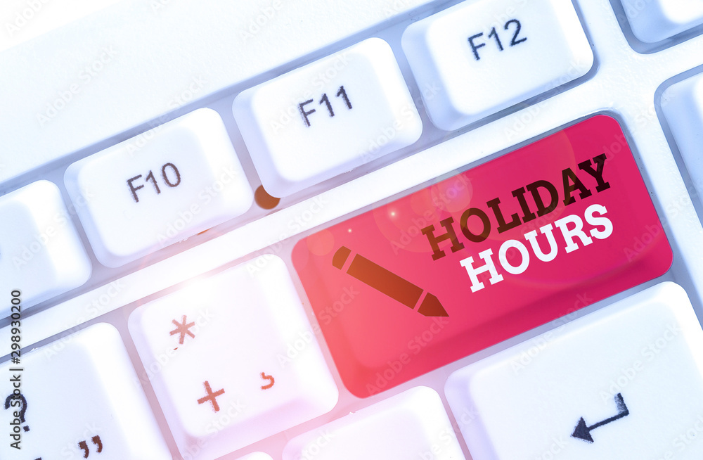Text sign showing Holiday Hours. Business photo showcasing employee receives twice their normal pay for all hours White pc keyboard with empty note paper above white background key copy space