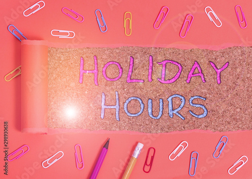 Word writing text Holiday Hours. Business photo showcasing employee receives twice their normal pay for all hours Stationary and torn cardboard placed above a wooden classic table backdrop photo