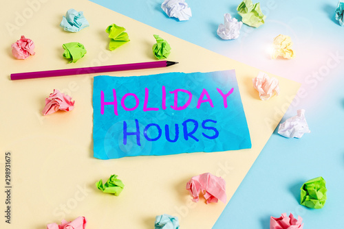Conceptual hand writing showing Holiday Hours. Concept meaning employee receives twice their normal pay for all hours Colored crumpled paper empty reminder blue yellow clothespin