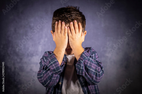 Fotografie Little child covering his eyes with his hands
