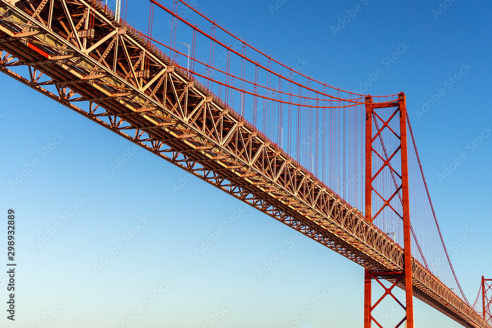 Fototapeta premium Red bridge, Lisbon, Portugal. Ponte 25 de Abril Suspension Bridge over the Tagus river.
