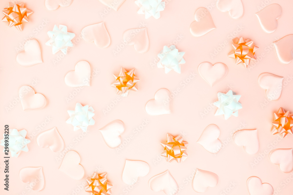 Beautiful silk hearts, white and orange holiday bows on a orange background, pastel colors . Celebrate concept. Flat lay . Beautiful silk hearts, white and orange holiday bows on a orange background, pastel colors . Celebrate concept. Flat lay .