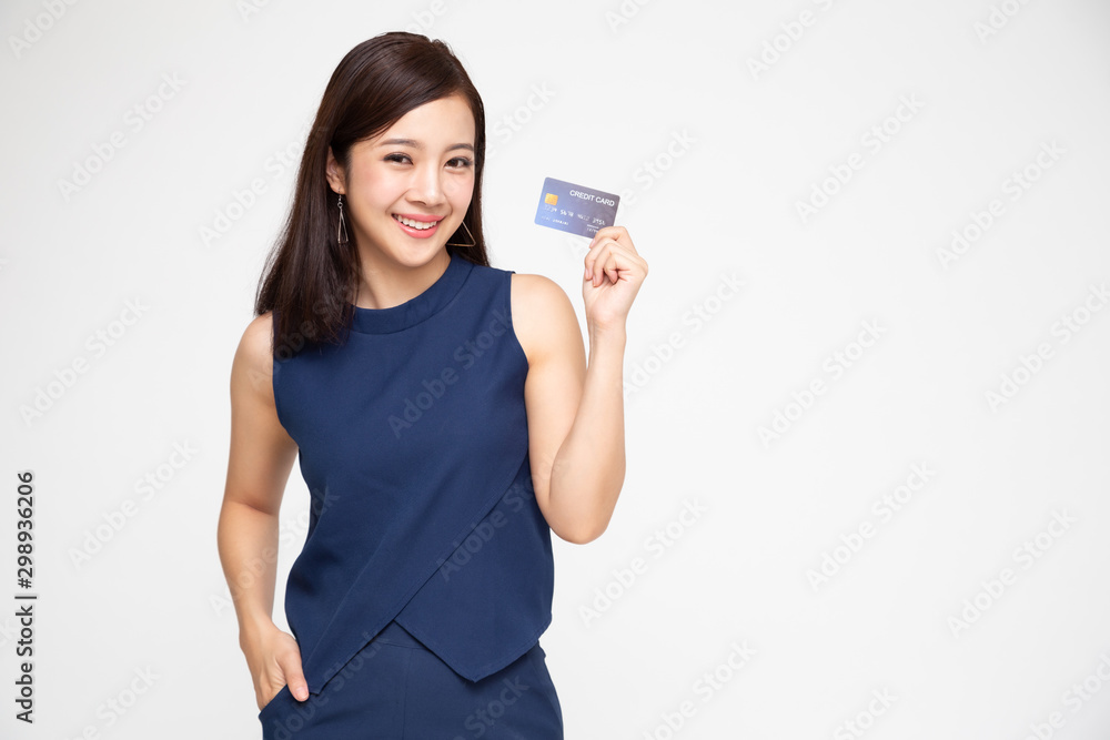 Young beautiful Asian woman smiling, showing, presenting credit card for making payment or paying online business, Pay a merchant or as a cash advance for goods, Cardholder or A person who owns a card Young beautiful Asian woman smiling, showing, presenting credit card for making payment or paying online business, Pay a merchant or as a cash advance for goods, Cardholder or A person who owns a card