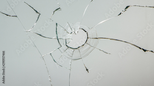 glass crack after window destruction on soft blue background